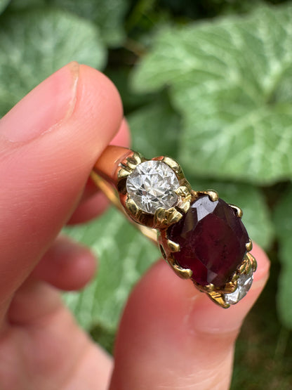 Antique 18ct yellow gold three stone 0.95ct flat cut garnet and 0.45ct TCW old European cut diamond ring