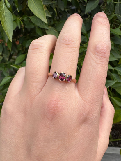 Antique 9ct rose gold three stone 0.7ct TCW garnet bezel set ring