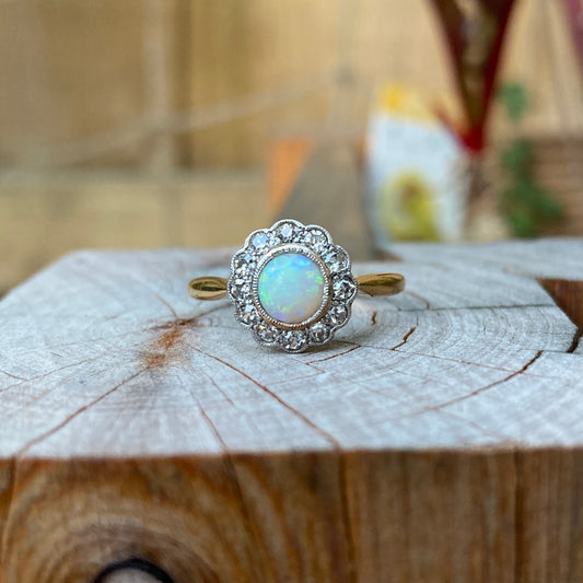 Vintage 18ct yellow gold opal cabochon and old cut diamond halo ring