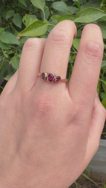 Antique 9ct rose gold three stone 0.7ct TCW garnet bezel set ring